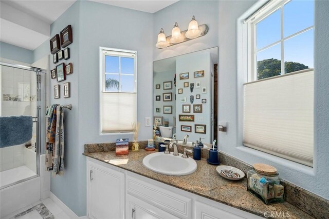 530 Bluerock Dr, San Luis Obispo, CA 93401 - full bathroom with vanity, plenty of natural light, and bath / shower combo with glass door