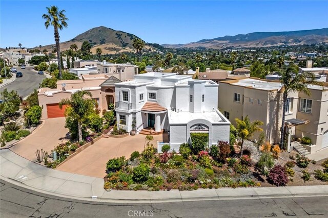 530 Bluerock Dr, San Luis Obispo, CA 93401 - view of front facade with driveway, a mountain view, a residential view, and stucco siding