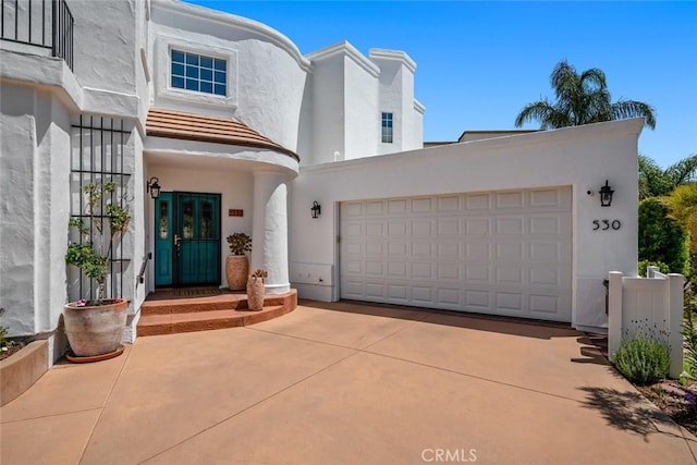 530 Bluerock Dr, San Luis Obispo, CA 93401 - view of front of house with stucco siding, concrete driveway, and an attached garage