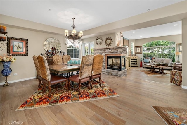 530 Bluerock Dr, San Luis Obispo, CA 93401 - dining room featuring wood finished floors, a chandelier, plenty of natural light, recessed lighting, and a stone fireplace
