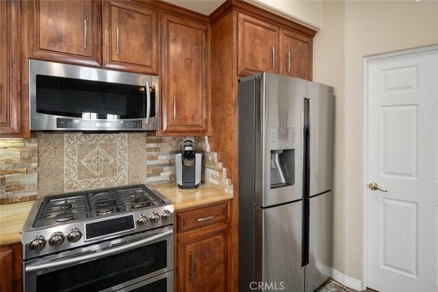 530 Bluerock Dr, San Luis Obispo, CA 93401 - kitchen with appliances with stainless steel finishes, light countertops, decorative backsplash, and brown cabinetry