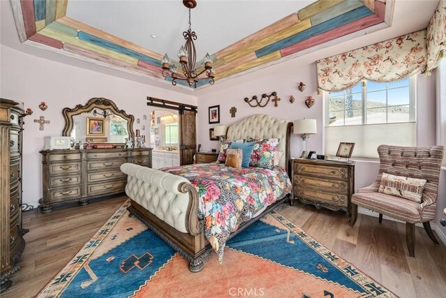 530 Bluerock Dr, San Luis Obispo, CA 93401 - bedroom with wood finished floors, a raised ceiling, and a chandelier