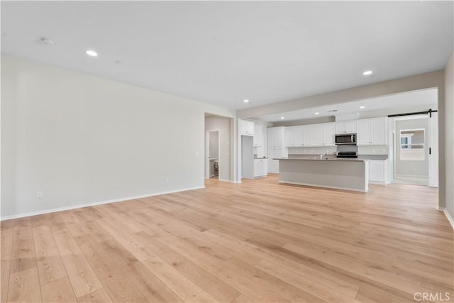 30071 Merrick Ln, Menifee, CA 92584 - unfurnished living room with light wood-style floors and recessed lighting