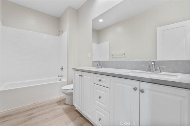30071 Merrick Ln, Menifee, CA 92584 - bathroom with double vanity, wood finished floors, and bathtub / shower combination