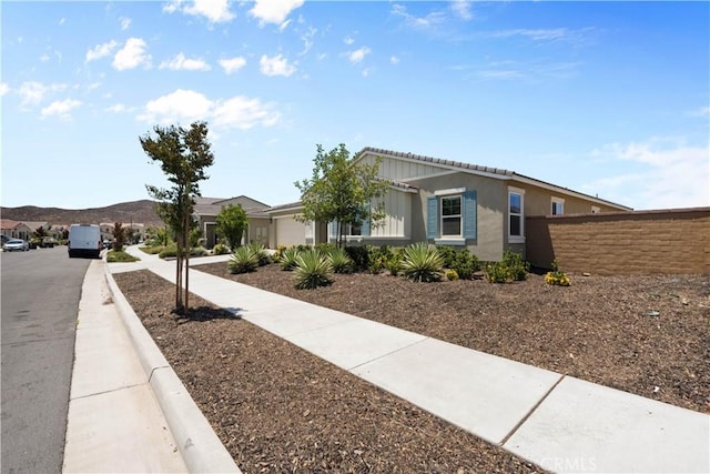 30071 Merrick Ln, Menifee, CA 92584 - ranch-style house with a garage, stucco siding, and a mountain view