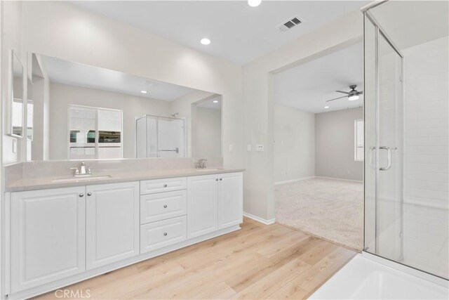 30071 Merrick Ln, Menifee, CA 92584 - full bath featuring double vanity, wood finished floors, a stall shower, a ceiling fan, and recessed lighting