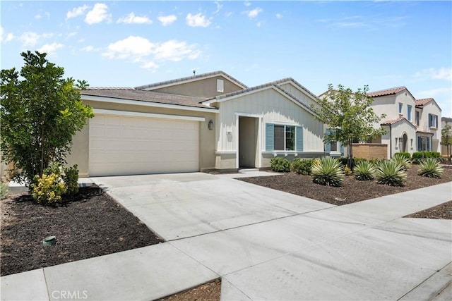 30071 Merrick Ln, Menifee, CA 92584 - view of front of home with an attached garage, concrete driveway, a tiled roof, and stucco siding
