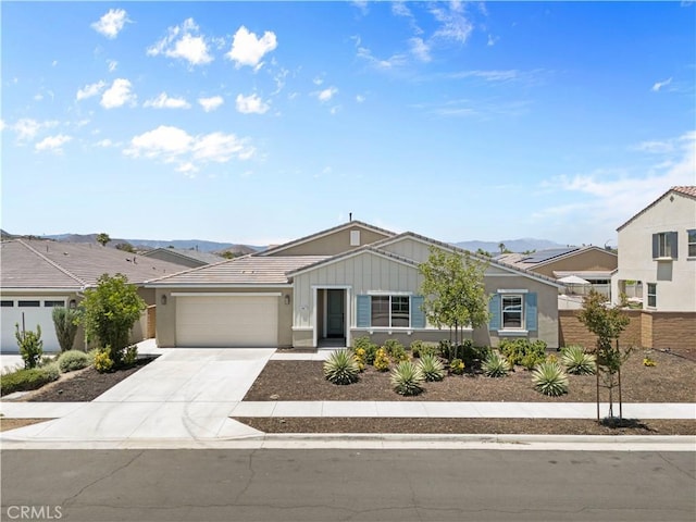 30071 Merrick Ln, Menifee, CA 92584 - ranch-style home featuring board and batten siding, a garage, driveway, a mountain view, and a tiled roof
