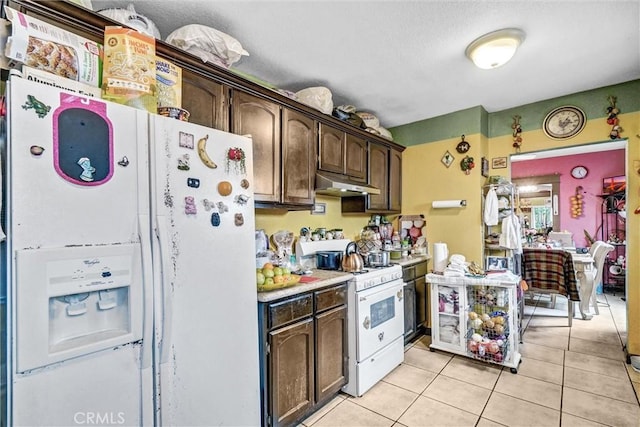 11847 Alabama St, Los Angeles, CA 90059 - kitchen featuring white appliances, under cabinet range hood, dark brown cabinetry, light countertops, and light tile patterned flooring