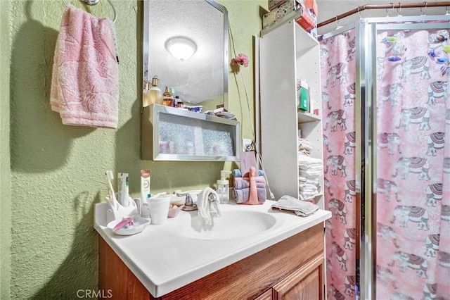 11847 Alabama St, Los Angeles, CA 90059 - bathroom featuring a textured wall, vanity, and a shower