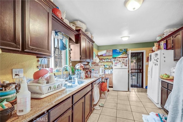 11847 Alabama St, Los Angeles, CA 90059 - kitchen featuring freestanding refrigerator, light countertops, light tile patterned flooring, and white refrigerator with ice dispenser