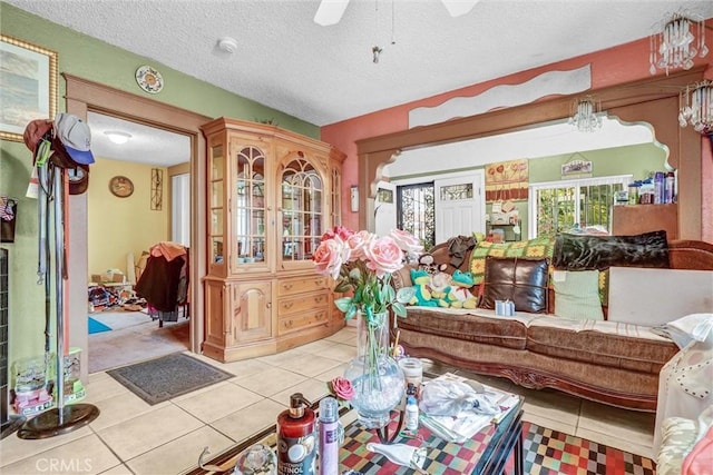 11847 Alabama St, Los Angeles, CA 90059 - living room featuring light tile patterned floors, a ceiling fan, and a textured ceiling