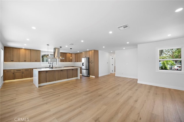 2405 Larchmont Ave, Santa Ana, CA 92706 - kitchen with stainless steel fridge with ice dispenser, open floor plan, recessed lighting, light countertops, and exhaust hood