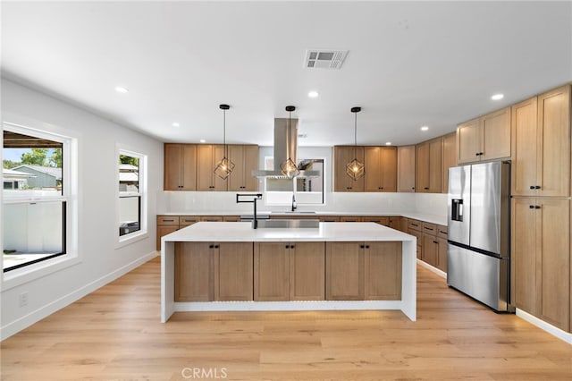 2405 Larchmont Ave, Santa Ana, CA 92706 - kitchen with stainless steel refrigerator with ice dispenser, island exhaust hood, a center island, light countertops, and recessed lighting