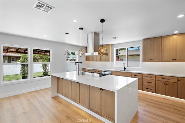 2405 Larchmont Ave, Santa Ana, CA 92706 - kitchen with island exhaust hood, light wood-style floors, a center island, plenty of natural light, and recessed lighting