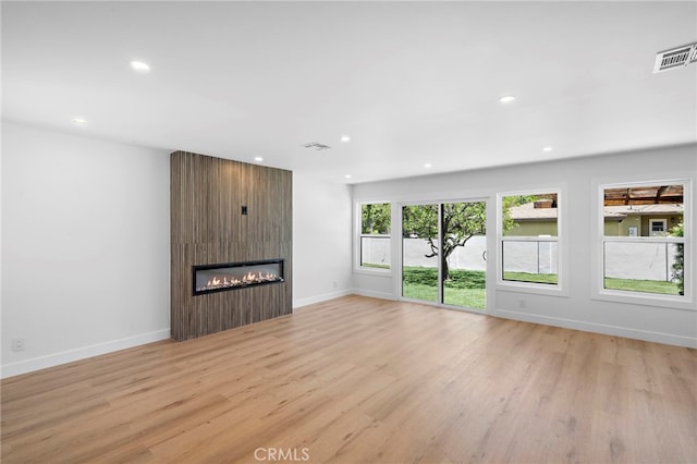 2405 Larchmont Ave, Santa Ana, CA 92706 - unfurnished living room featuring a fireplace, light wood-style floors, and recessed lighting