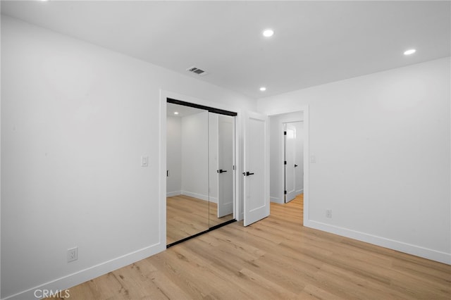 2405 Larchmont Ave, Santa Ana, CA 92706 - unfurnished bedroom featuring light wood-style flooring, recessed lighting, and a closet
