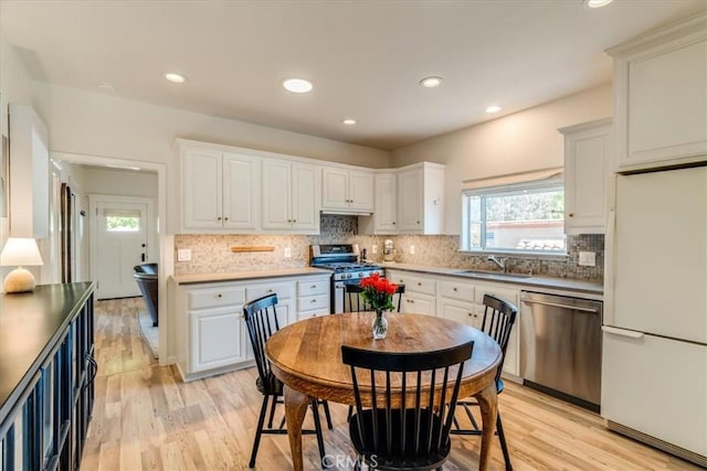 680 Howard St, San Luis Obispo, CA 93401 - kitchen featuring appliances with stainless steel finishes, backsplash, light wood-style flooring, and recessed lighting