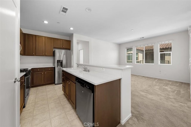 1708 Presidio Pl Unit 1, Chula Vista, CA 91913 - kitchen featuring appliances with stainless steel finishes, light countertops, recessed lighting, a center island with sink, and light carpet