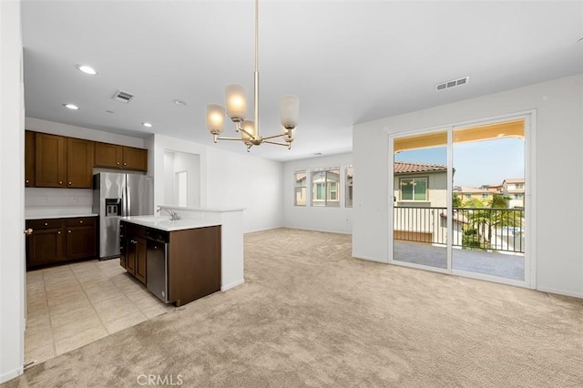 1708 Presidio Pl Unit 1, Chula Vista, CA 91913 - kitchen with stainless steel fridge, open floor plan, a chandelier, light countertops, and light carpet