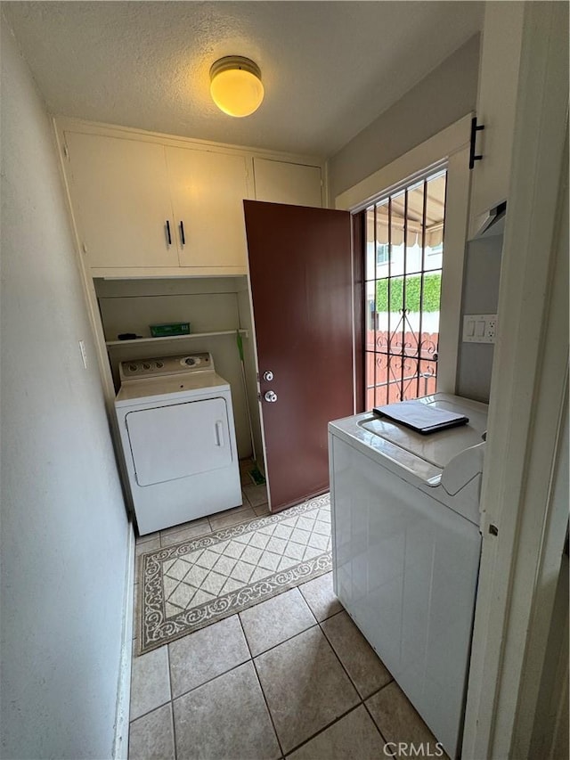 714 E Chapman Ave, Fullerton, CA 92831 - washroom featuring washer / clothes dryer, light tile patterned flooring, cabinet space, and a textured ceiling