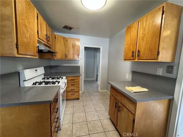714 E Chapman Ave, Fullerton, CA 92831 - kitchen featuring white range with gas cooktop, under cabinet range hood, dark countertops, light tile patterned floors, and brown cabinetry