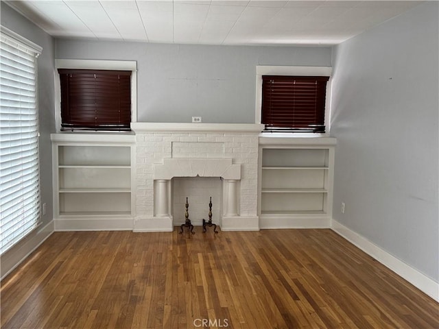 714 E Chapman Ave, Fullerton, CA 92831 - unfurnished living room with wood finished floors and a fireplace