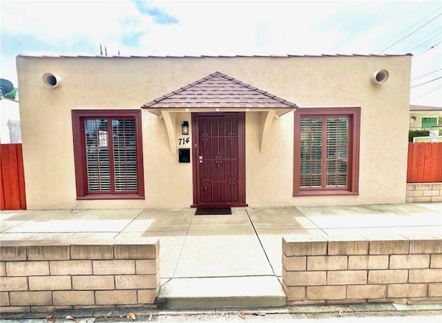 714 E Chapman Ave, Fullerton, CA 92831 - doorway to property with stucco siding and roof with shingles