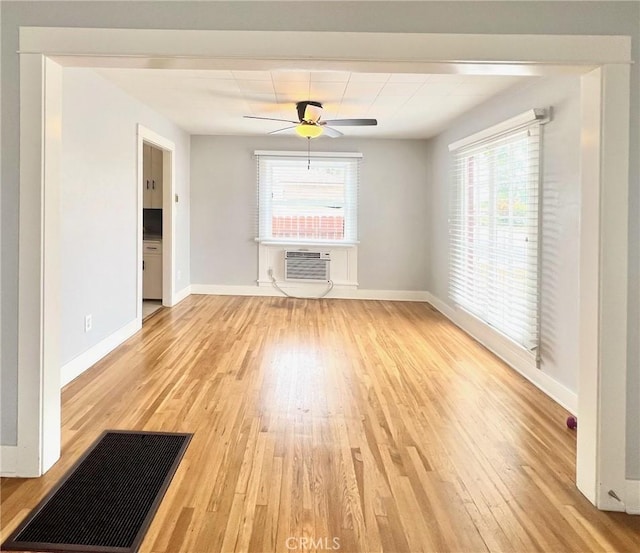 714 E Chapman Ave, Fullerton, CA 92831 - unfurnished living room featuring light wood-style flooring, a wall mounted air conditioner, and a ceiling fan