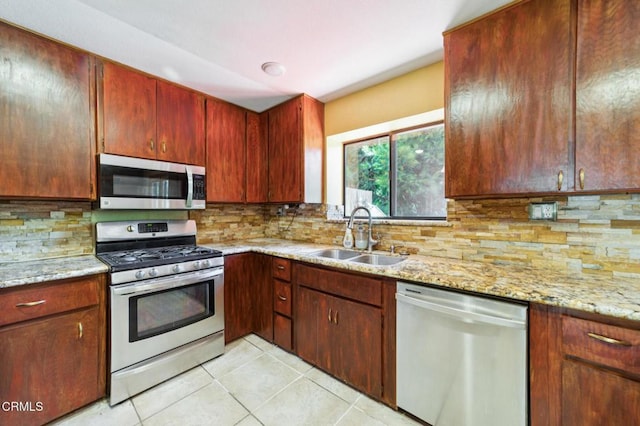 352 Cedarbrook Dr, Twin Peaks, CA 92391 - kitchen with appliances with stainless steel finishes, light tile patterned floors, decorative backsplash, and light stone counters