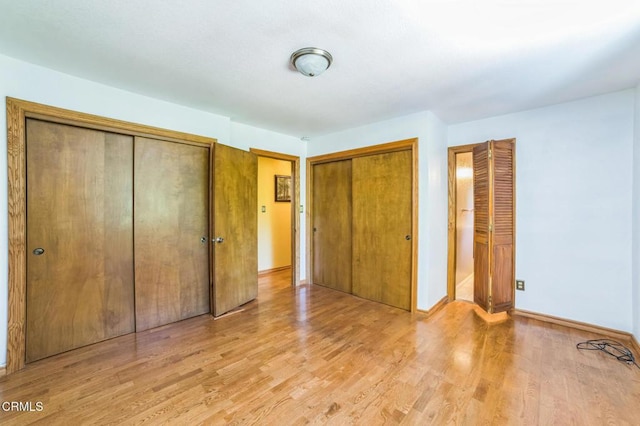 352 Cedarbrook Dr, Twin Peaks, CA 92391 - unfurnished bedroom with two closets and light wood-style flooring