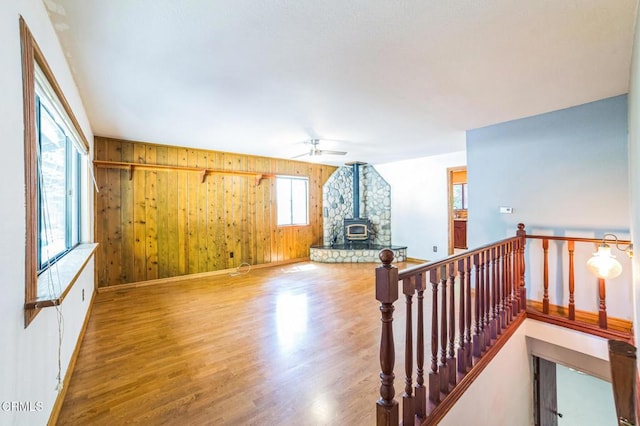 352 Cedarbrook Dr, Twin Peaks, CA 92391 - living room featuring wood finished floors, wooden walls, a wood stove, and ceiling fan