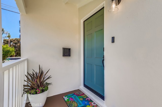 2609 S Leland St, San Pedro, CA 90731 - view of exterior entry featuring stucco siding and a balcony