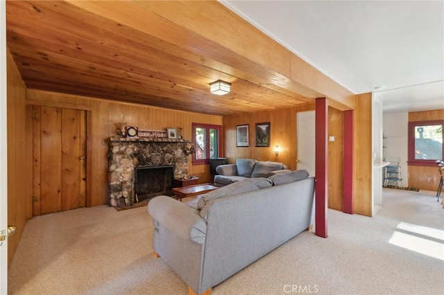 83634 Presidents Ln, Wilsona Gardens, CA 93633 - carpeted living area featuring wooden walls, a stone fireplace, and wood ceiling