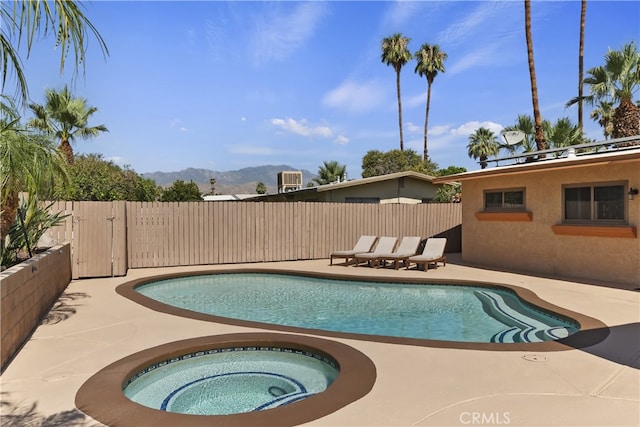 74183 Aster Dr, Palm Desert, CA 92260 - view of swimming pool with a patio area, a mountain view, and an in-ground hot tub