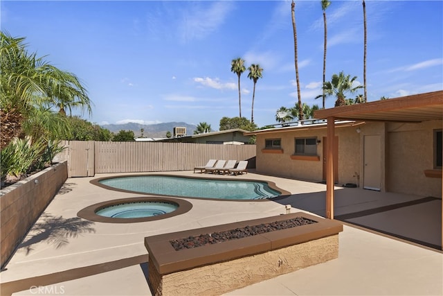 74183 Aster Dr, Palm Desert, CA 92260 - view of pool with a patio area, an in-ground hot tub, a fire pit, and a mountain view