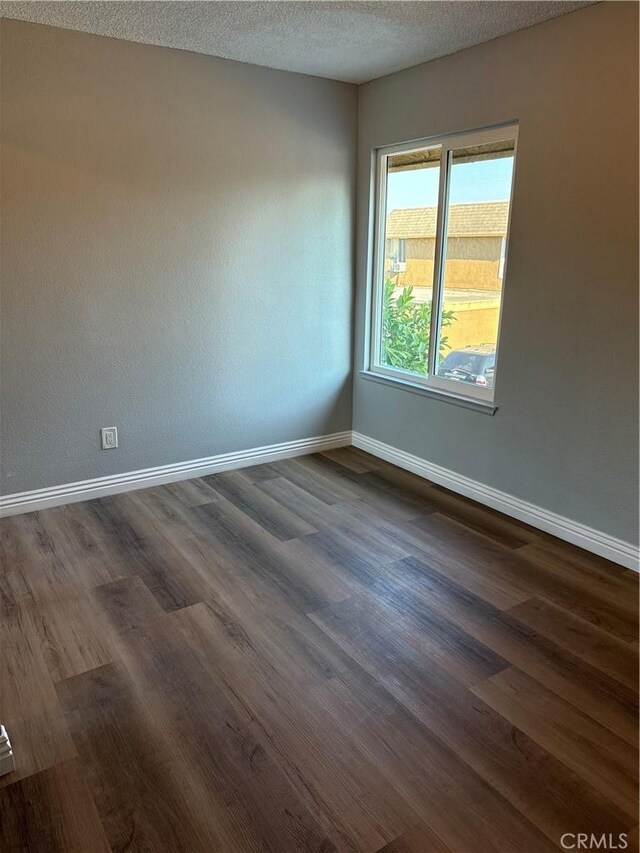 1323 S Standard Ave Unit A, Santa Ana, CA 92707 - empty room with dark wood-style flooring and a textured ceiling