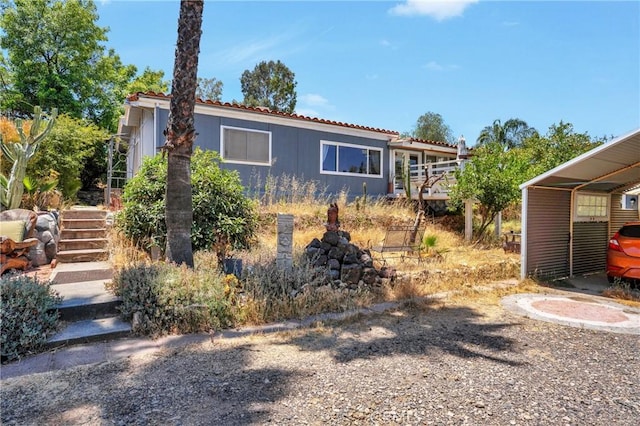 32303 Bilton Way, Wildomar, CA 92595 - view of front of home with stairway, a tile roof, a wooden deck, and a detached carport