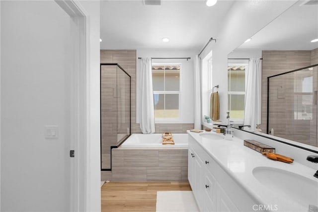 389 Allen Dr, Santa Paula, CA 93060 - full bath with a stall shower, a garden tub, double vanity, recessed lighting, and wood finished floors