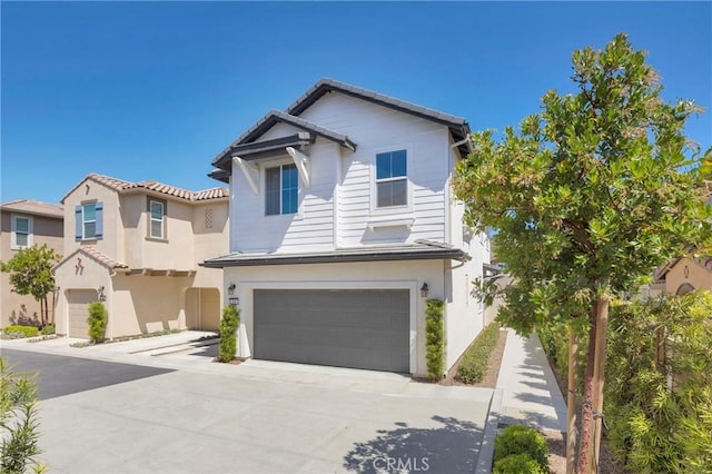 389 Allen Dr, Santa Paula, CA 93060 - view of front of house featuring an attached garage, driveway, and stucco siding
