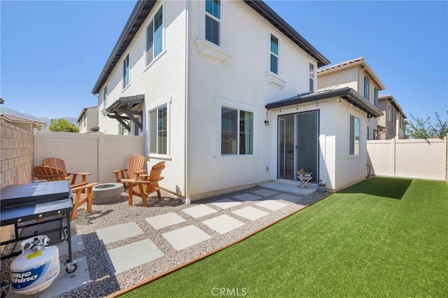 389 Allen Dr, Santa Paula, CA 93060 - rear view of property with a fenced backyard, a patio, an outdoor fire pit, and stucco siding