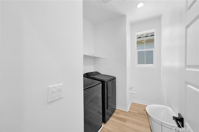 389 Allen Dr, Santa Paula, CA 93060 - laundry room with washing machine and clothes dryer and light wood-type flooring