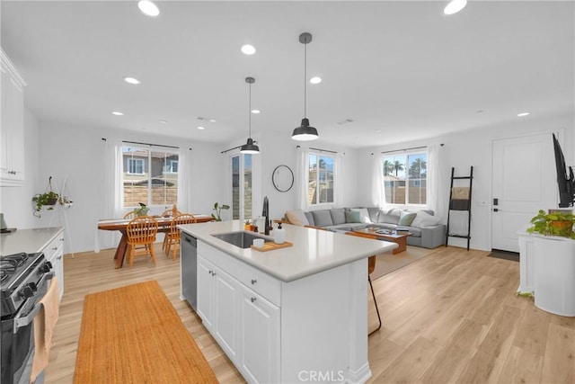 389 Allen Dr, Santa Paula, CA 93060 - kitchen featuring gas stove, stainless steel dishwasher, light wood-style floors, white cabinets, and recessed lighting