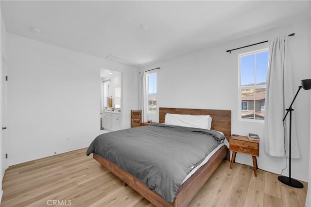389 Allen Dr, Santa Paula, CA 93060 - bedroom featuring light wood-type flooring, multiple windows, and ensuite bath