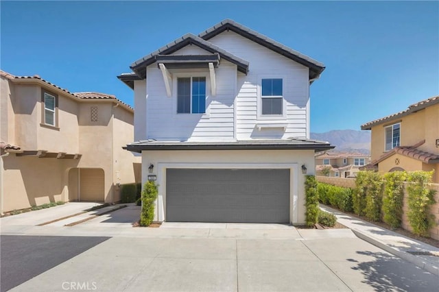 389 Allen Dr, Santa Paula, CA 93060 - traditional-style home with a garage, a mountain view, driveway, and stucco siding