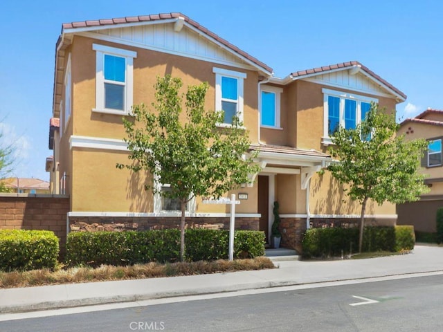 7911 Cold Creek St, Riverside, CA 92507 - view of front of home with a tile roof, stone siding, and stucco siding