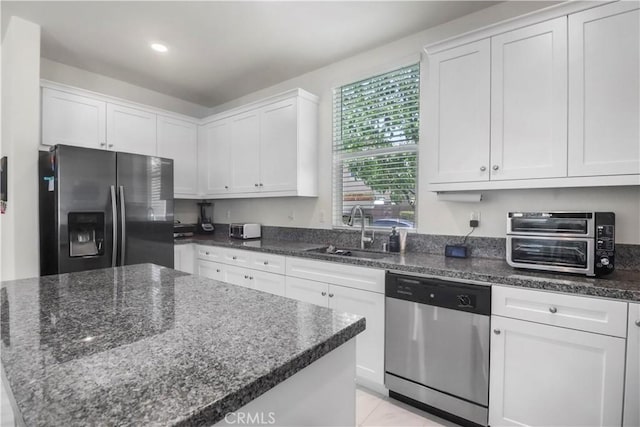7911 Cold Creek St, Riverside, CA 92507 - kitchen featuring stainless steel appliances, white cabinetry, dark stone countertops, a kitchen island, and recessed lighting