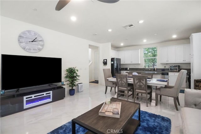 7911 Cold Creek St, Riverside, CA 92507 - living area with ceiling fan, recessed lighting, and light marble finish flooring