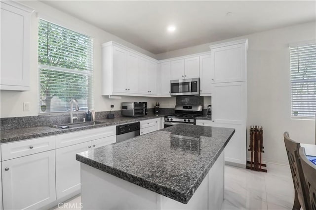 7911 Cold Creek St, Riverside, CA 92507 - kitchen featuring appliances with stainless steel finishes, light marble finish floors, white cabinets, and healthy amount of natural light