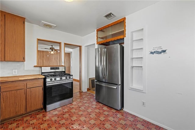 7737 Nestle Ave, Reseda, CA 91335 - kitchen featuring stainless steel appliances, tasteful backsplash, brown cabinets, and a ceiling fan